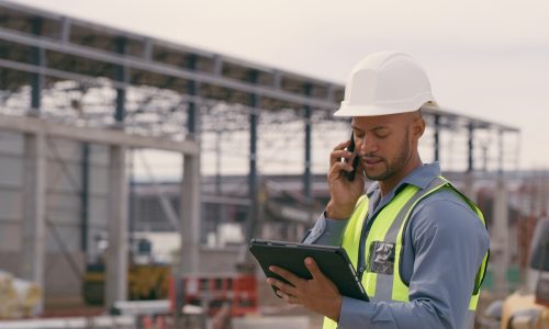 Man, construction and tablet with phone call at site for project management or building logistics. Male person and engineering worker talking on technology at industrial architecture design